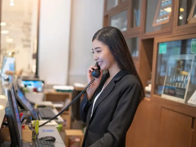  Elegant hotel lobby with guests checking in at the front desk.