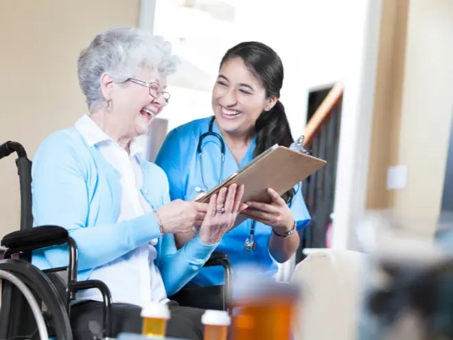 Assisted living facility with landscaped gardens and elderly residents outdoors.